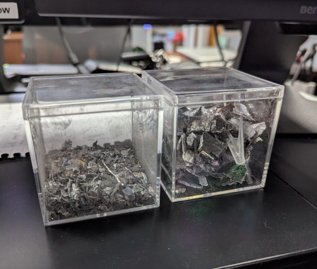 Two transparent containers showing hard drive fragments before and after shredding, demonstrating secure data destruction at BCC IT.