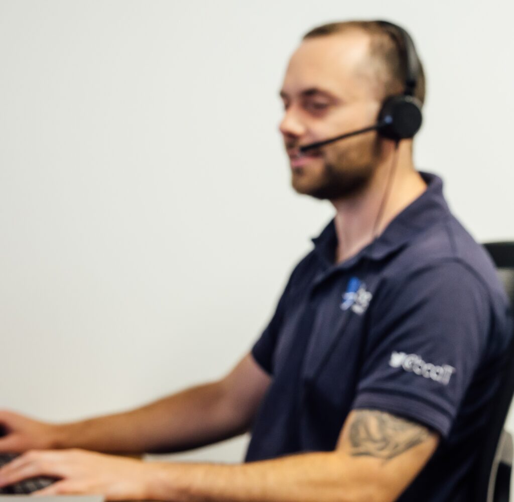 BCC IT support agent Adrian Hutton assisting a customer on the support desk. Adrian is leaving the team in October after years of dedicated service.