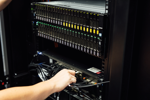 Secure business server with cybersecurity approval tick, representing protected IT infrastructure and resilient business systems.