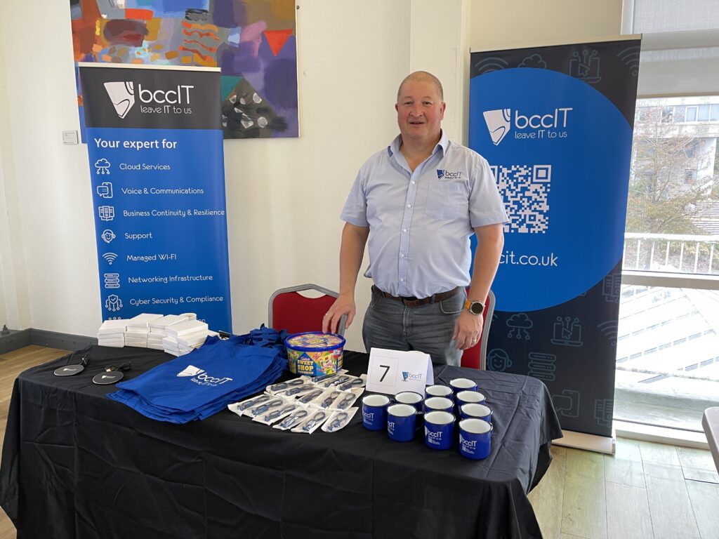 BCC IT Director Hywel Ifans standing at the Company's stand during the Aberystwyth Recruitment Fair, showcasing career opportunities and engaging with attendees at the University