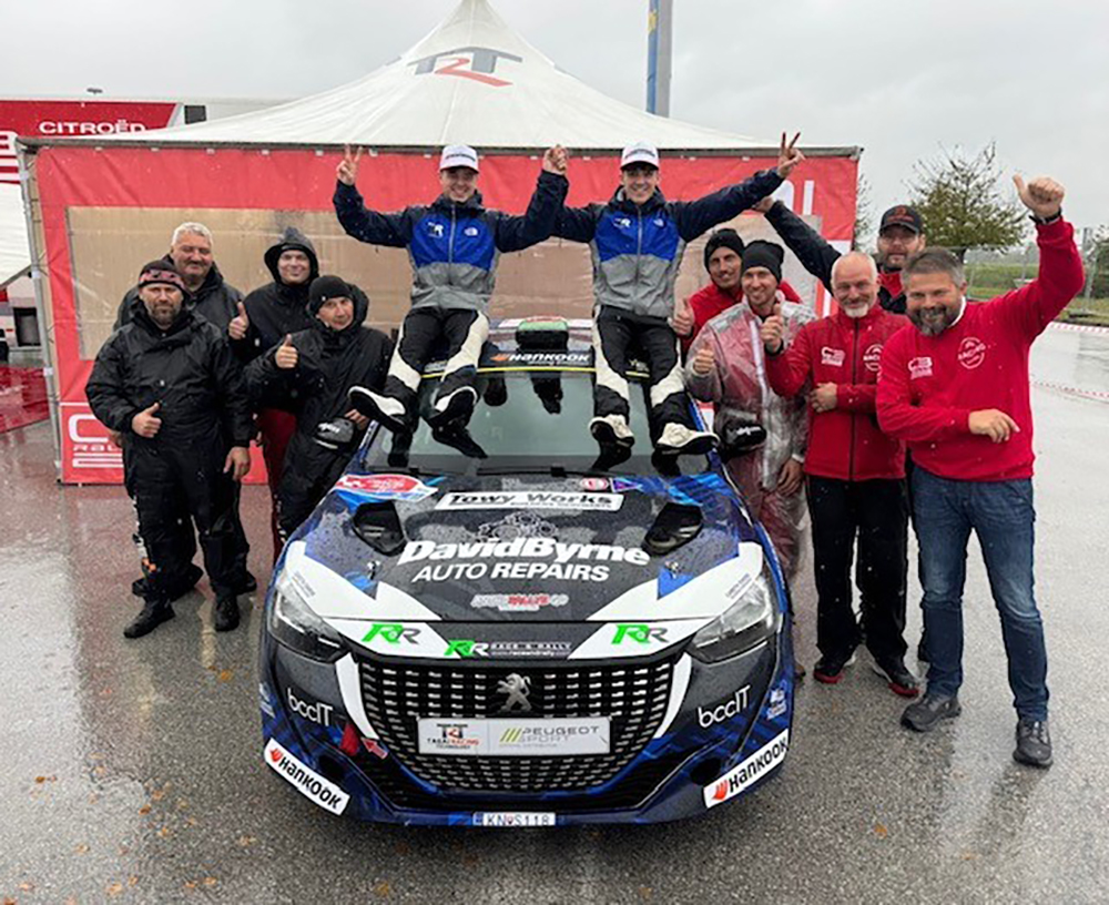 Ioan Lloyd and Sion Williams beside their Peugeot 208 Rally4 car ahead of the Croatia Rally.