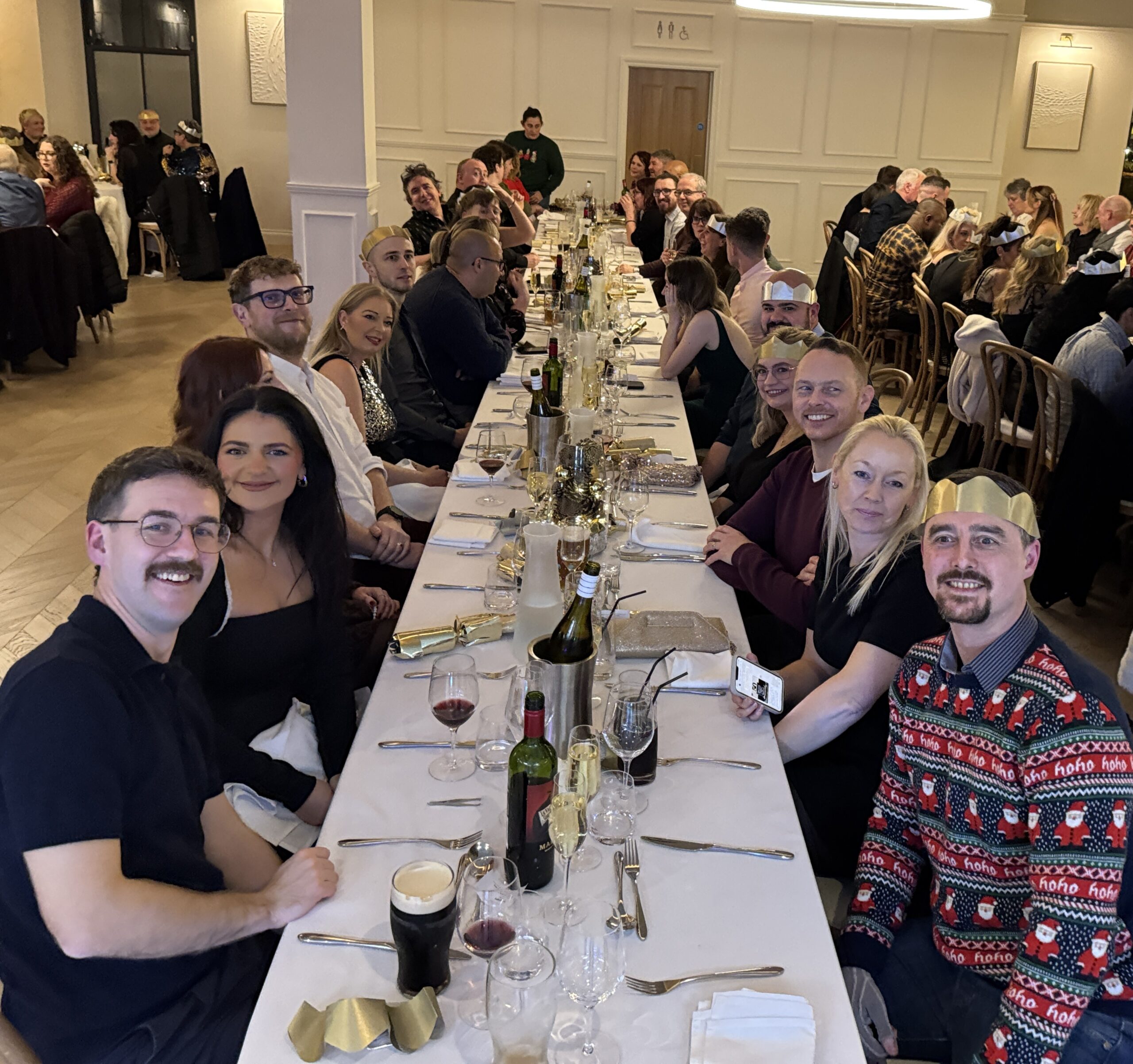 BCC IT team and their partners seated at a long dining table during the annual Christmas party and festive meal at Ty Glyn, in Ciliau Aeron, near Lampeter celebrating the end of 2025.