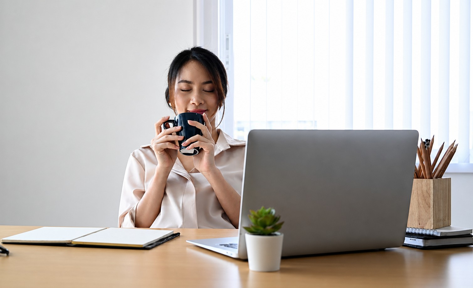 a relaxed office worker taking a short break at laptop, representing annual leave planning and business continuity during annual leave to reduce disruption during annual leave and holiday handovers