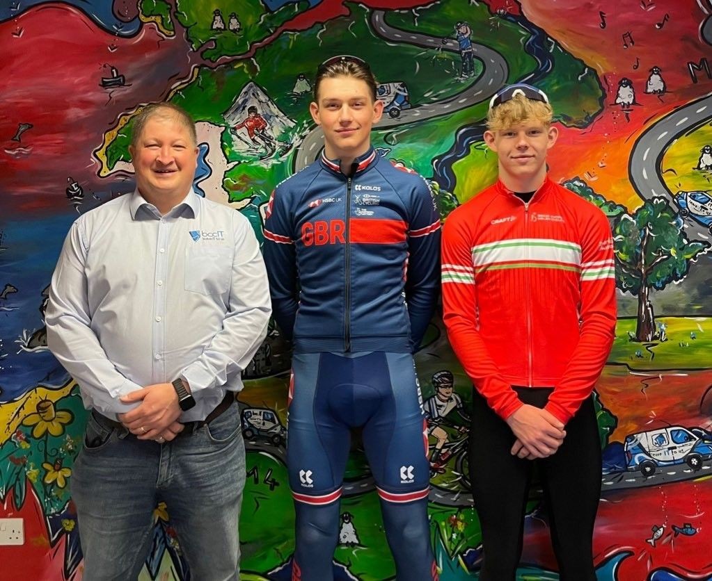 Photograph taking at the BCCIT office in Newcastle Emlyn of (from L-R), Bcc Managing Director Hywel Ifans alongside Welsh cyclists Josh and Fin Tarling.